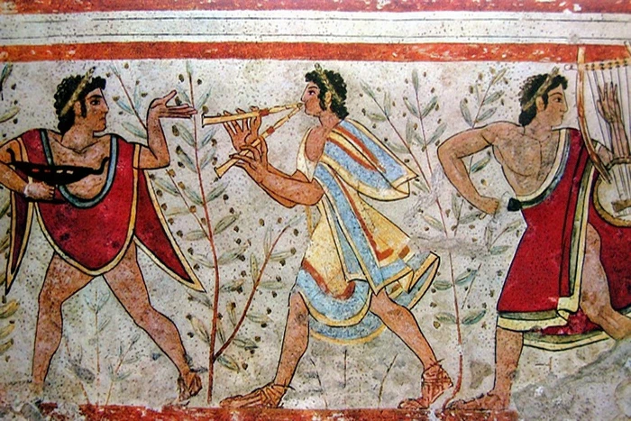 Detalle de un fresco etrusco con músicos tocando la flauta y la lira durante una escena festiva.
